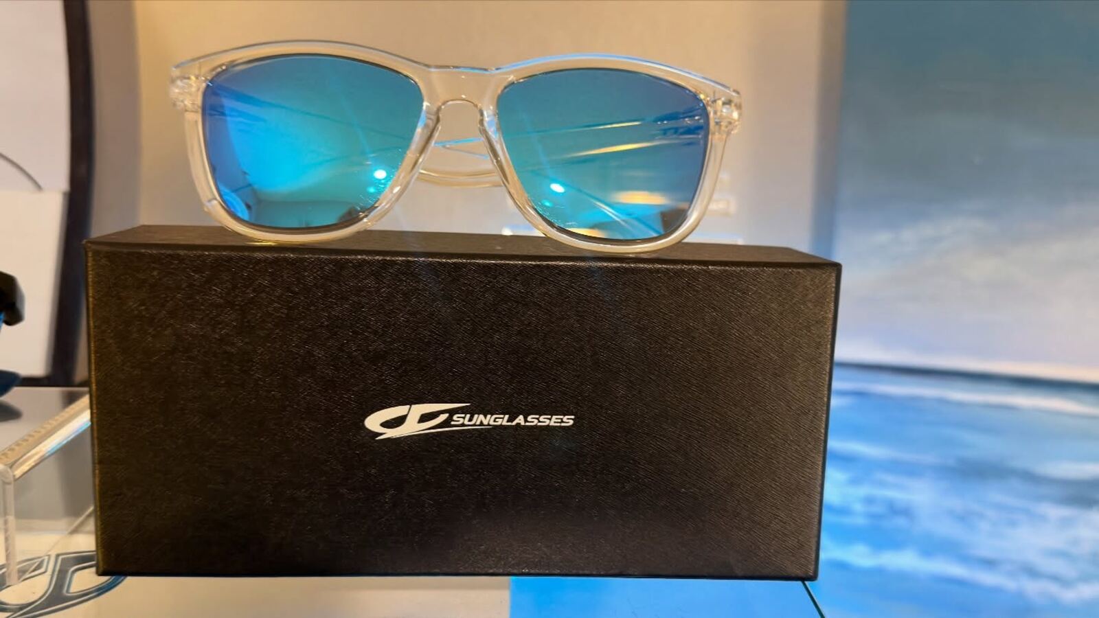 JC Signature sunglasses on branded box